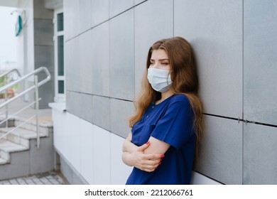 Portrait Of A Nurse In A Protective Mask Outside The Clinic. Difficult Work Shift During A Pandemic.