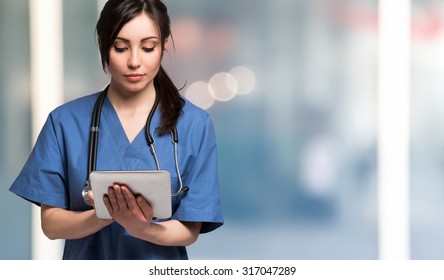 Portrait of a nurse using a digital tablet. Large copy-space