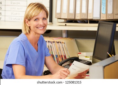 Portrait Of Nurse Working At Nurses Station