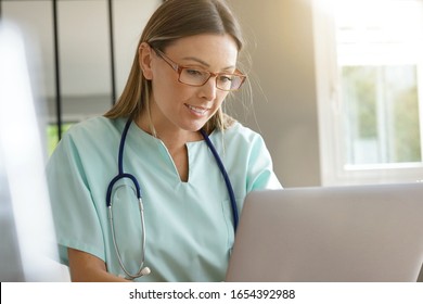 Portrait Of Nurse Working On Laptop Computer