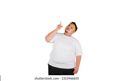 Portrait Of An Obese Man Wearing Sportswear While Thinking Something, Isolated On White Background