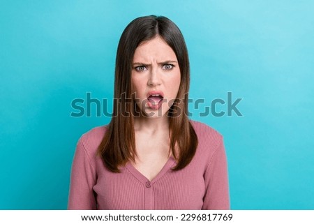 Portrait of offended dissatisfied woman with stylish hairstyle wear purple shirt staring open mouth isolated on blue color background