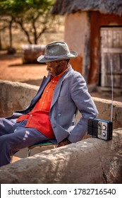 Portrait Of An Old African Man Listening To His Radio In A Village In A Botswana