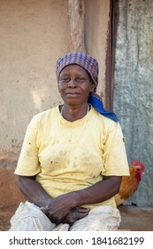 Portrait Of An Old African Woman Next To The Wall  In Her Village In Botswana