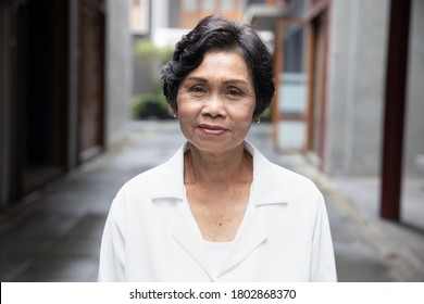 Portrait Of Old Asian Senior Woman With Wrinkle Skin And Black Dyed Hair