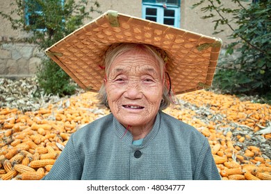 Portrait Of A Old Chinese Women.She Is Working In Yard Of Her House.