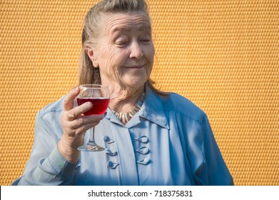 Portrait Of Old Farmer, Businesswoman, Grandmother Outdoors At Sun Day. Caucasian Granny Drinking Red Wine. Elderly Woman Enjoying Taste Alcohol, Hold Glass . Positive Senior Lady Drink Beverage
