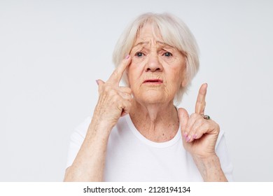 Portrait of an old friendly woman vision problems myopia light background