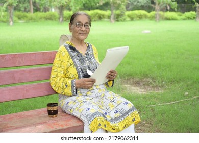 Portrait Of An Old Lady Reading Newspaper