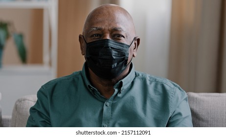 Portrait Old Lonely African Dominican Mature Man 60s Grandfather Mature Senior Male Sad Pensive Patient In Black Medical Mask At Home Indoors Looking At Camera Isolation Covid Coronavirus Pandemic