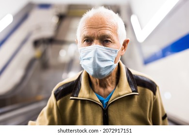 Portrait of old man in face mask standing on escalator while going up from subway. - Powered by Shutterstock