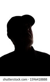 Portrait of a old man, in a peaked cap, with beard, side view - dark isolated silhouette