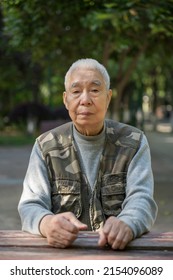 Portrait Of An Old Man Sitting Behind A Desk