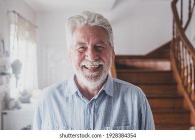 Portrait Of Old Man Smiling And Looking At The Camera Having Fun Indoor At Home. Closeup Male Person Senior Cheerful Indoor.
