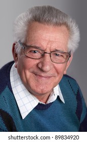 Portrait Of An Old Man Smiling, Looking At Camera, In Studio.