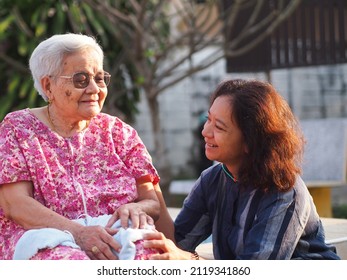 Portrait Of Old Mother With Cheerful Woman Taking Care Of Her Mom. Happy Asian Senior Family Concept.