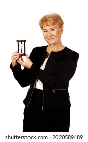 A Portrait Of An Old Polish Woman In A Black Suit Holding A Vintage Hourglass, Isolated On White