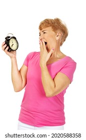 A Portrait Of An Old Polish Woman Laughing While Looking At Her Black Alarm Clock, Isolated On White