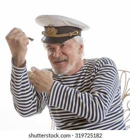Portrait of old sailor man in striped shirt and hat holding smoking pipe  isolated on white background