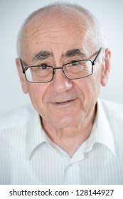 Portrait Of Old Smiling Man And Wearing Glasses On White Background