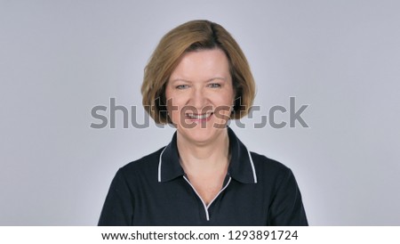 Portrait of Old Smiling Woman Looking at Camera