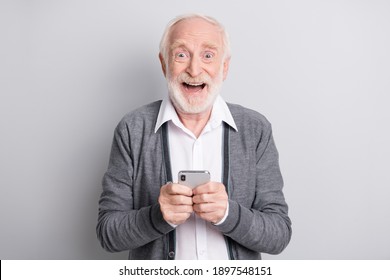 Portrait of old white hair hooray man hold telephone wear dark sweater isolated on grey background