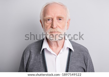 Portrait of old white hair sad man wear dark sweater isolated on grey background