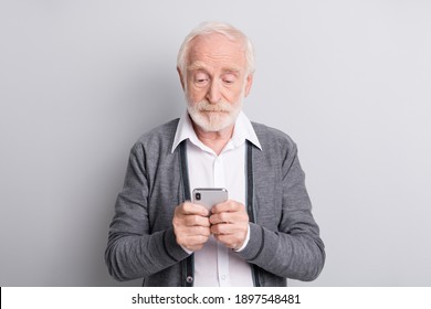 Portrait of old white hair serious man type telephone wear dark sweater isolated on grey background
