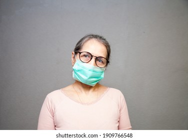 Portrait Of  Old Woman, 55 Years Old, In  Medical Mask.  Concept Of  Dangers Of Coronavirus For  Elderly