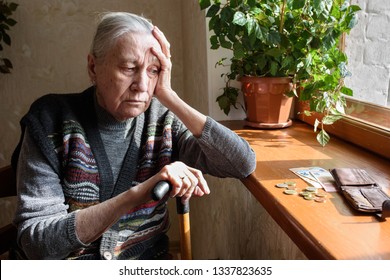 Portrait of an old woman counting money. The concept of old age, poverty, austerity. - Shutterstock ID 1337823635