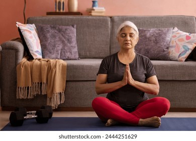 Portrait of an old woman meditating at home - Powered by Shutterstock