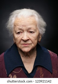 Portrait Of Old Woman On A Gray Background