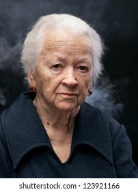 Portrait Of Old Woman On A Gray Background