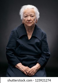 Portrait Of Old Woman On A Gray Background