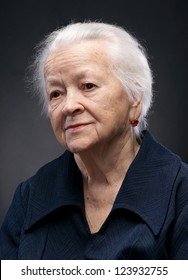 Portrait Of Old Woman On A Gray Background