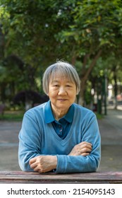 Portrait Of An Old Woman Sitting Besides A Desk