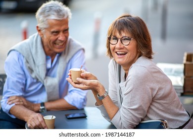 Portrait older couple enjoying cup of coffee outside