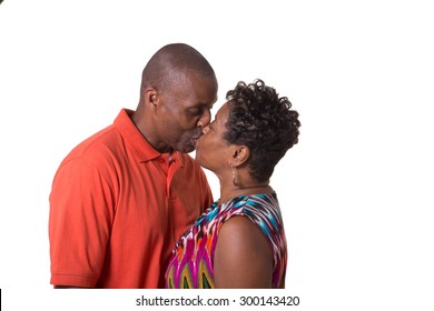 Portrait Of An Older Couple Facing Kissing, Isolated