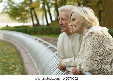 Portrait Older Couple Walking In The Autumn Park