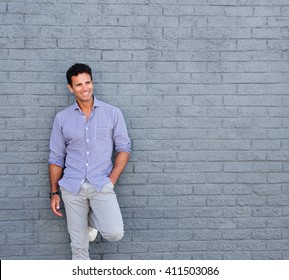 Portrait Of A Older Male Fashion Model Smiling Against  Gray Background