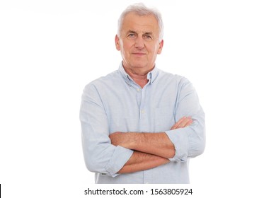 Portrait Of Older Man In Grey Shirt Looking At Camera.