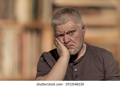 Portrait Of An Older Man Sitting Passively And Disinterested In A Room