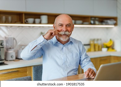 Portrait Of Older Man, Sitting And Posing For Camera.