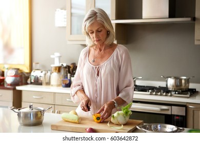 Portrait Of Older Woman In Kitchen Preparing Healthy Meal