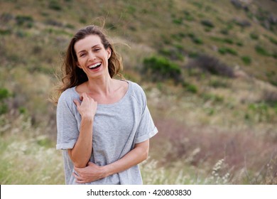 Portrait Of Older Woman Laughing In Field 