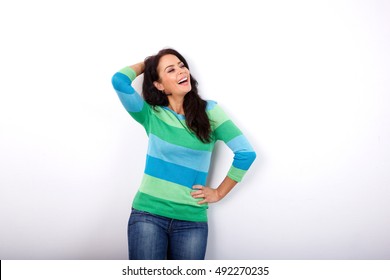 Portrait Of Older Woman Laughing With Hand In Hair Against White Background 