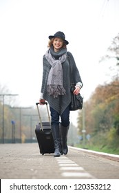 Portrait Of A Older Woman Walking On Train Platform With Bag