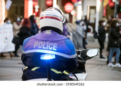 Portrait On Back View Of French Biker Policeman In The Street During A Protesting Demonstration  In The Street