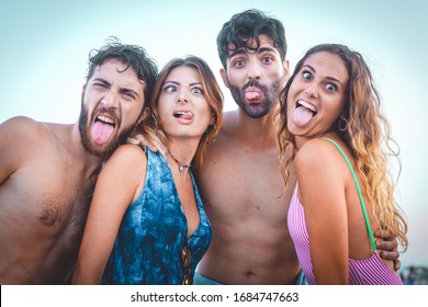 Portrait On Beach. Young People Having Fun Making Weird Grimaces Outdoor In The Summer.