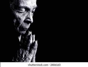 Portrait on Black Of Old woman Praying